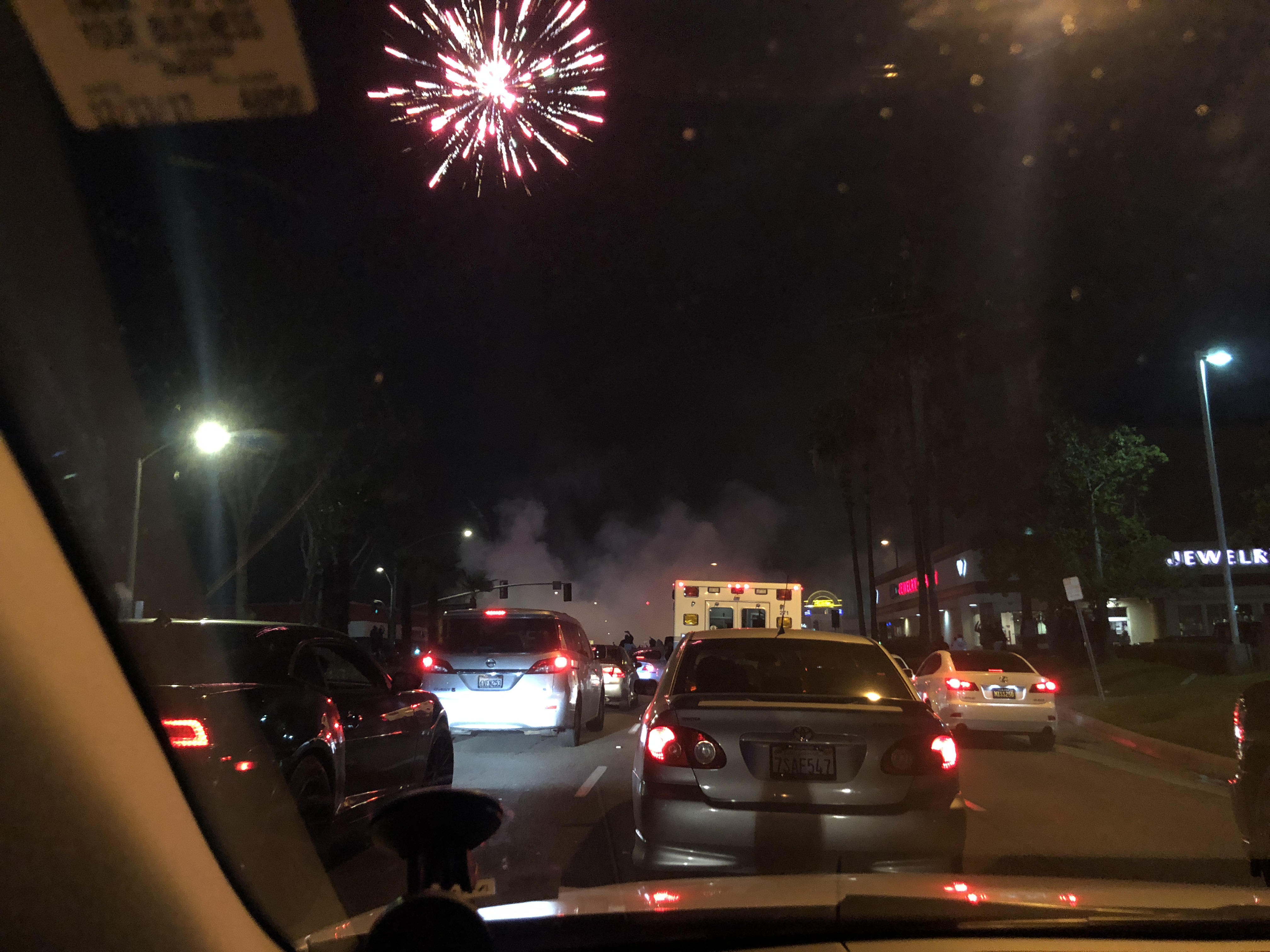 This photo, taken by a driver in Fullerton, shows fireworks and smoke from a car during a massive meetup of car enthusiasts. (Courtesy photo)